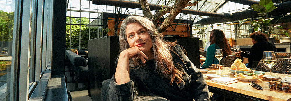 Mid-life woman relaxing in a sunlit café